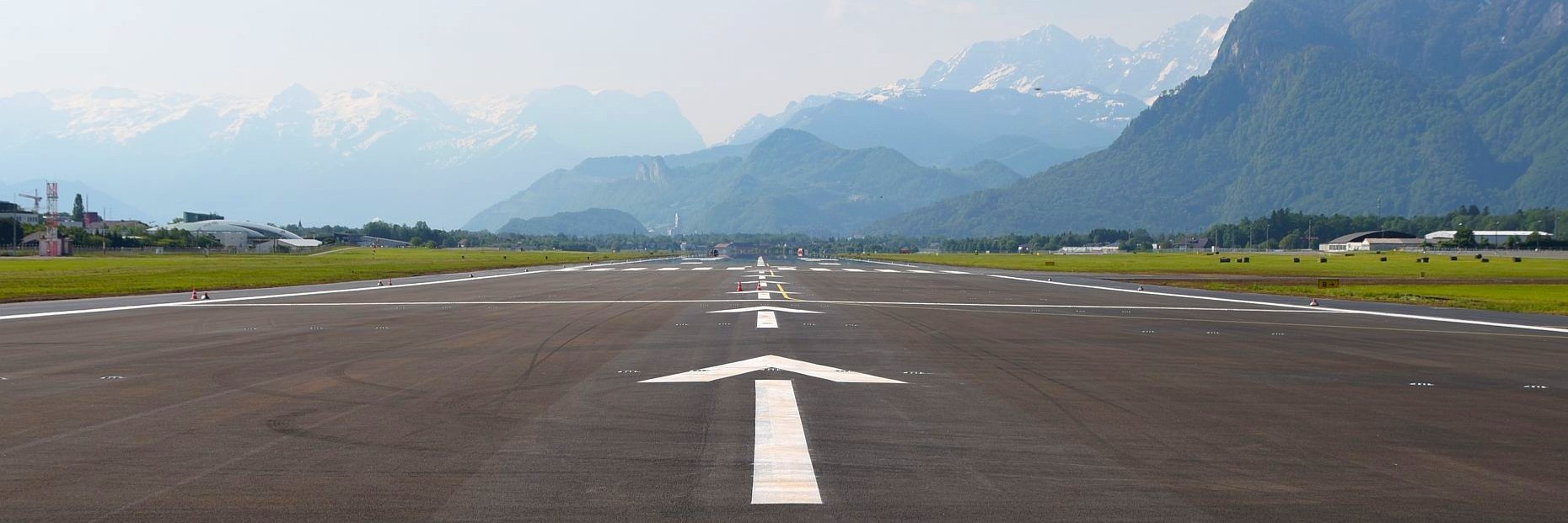 airport runway with high mountains in front