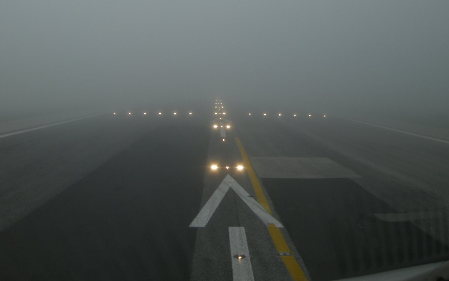 airport runway with fog