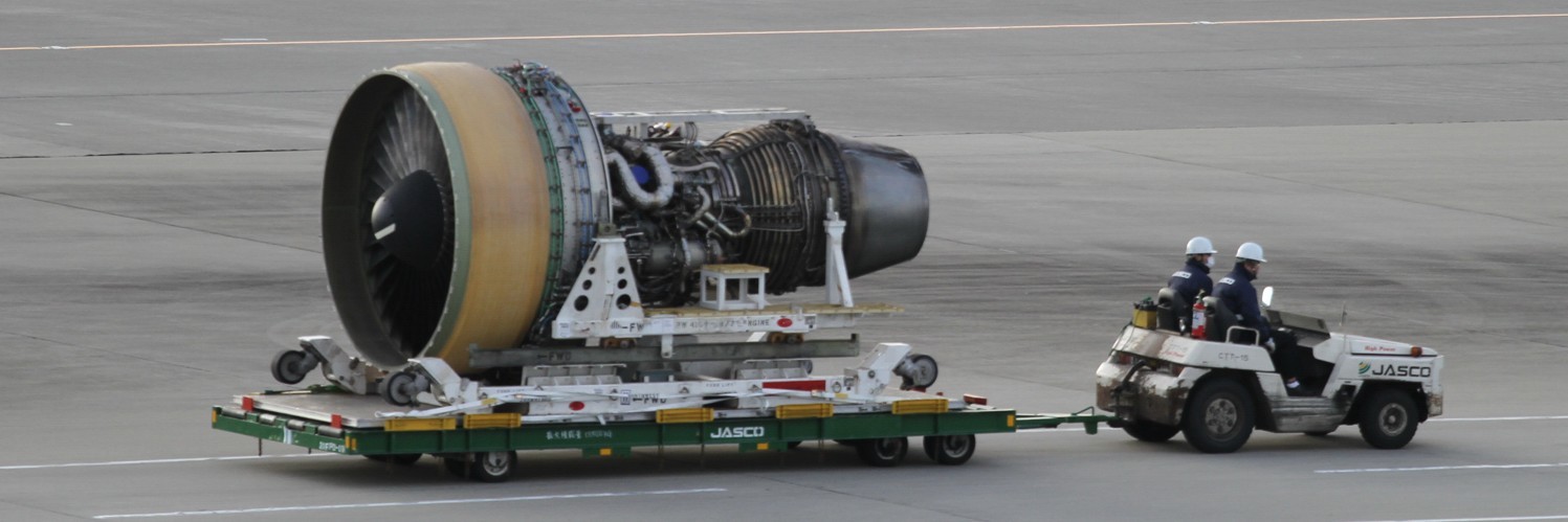 jet engine being towed at an airport