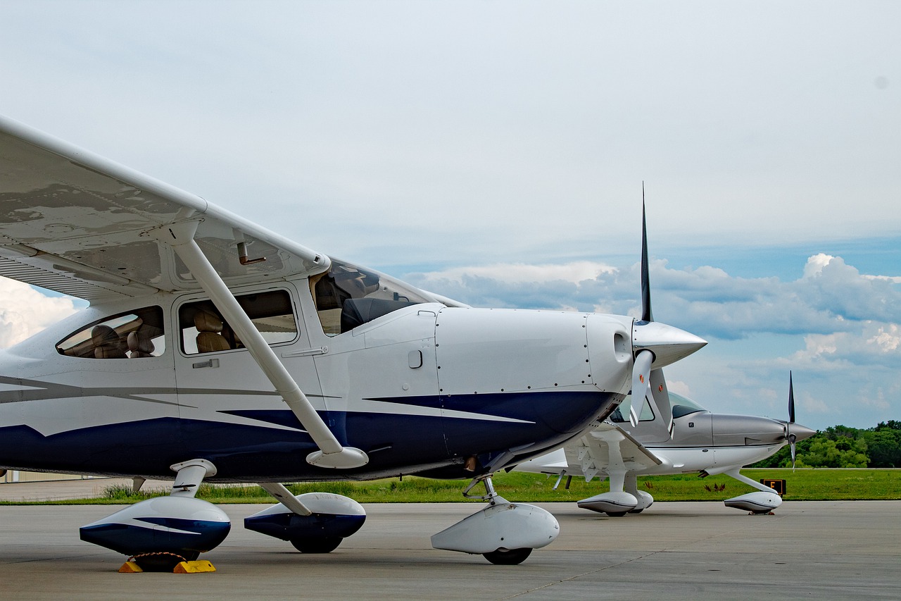 two cessna cirrus planes in a runway