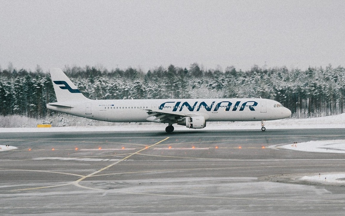 finnair plane in a runway with snow